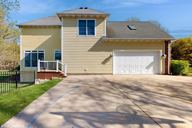 7272 Holden Rd, Stevensville, MI 49127 - view of front of house featuring a shingled roof, driveway, fence, and a garage