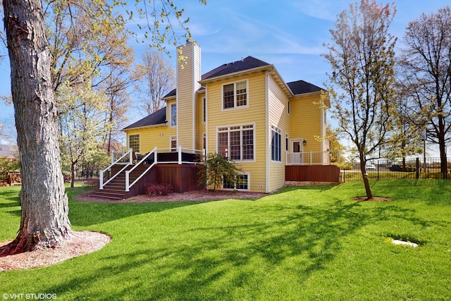 7272 Holden Rd, Stevensville, MI 49127 - back of house featuring a chimney, a lawn, fence, stairs, and a wooden deck