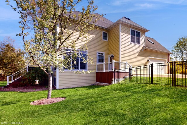 7272 Holden Rd, Stevensville, MI 49127 - rear view of house with stairway, roof with shingles, fence, and a lawn