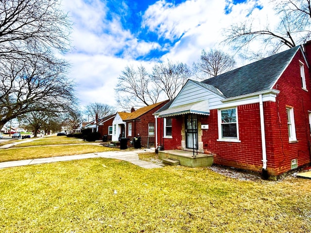 16476 Rossini Dr, Detroit, MI 48205 - bungalow-style home with brick siding, roof with shingles, and a front yard