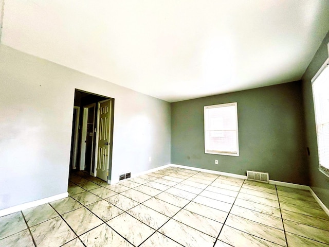 16476 Rossini Dr, Detroit, MI 48205 - unfurnished room featuring baseboards, a healthy amount of sunlight, and visible vents