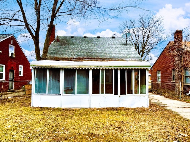 16476 Rossini Dr, Detroit, MI 48205 - back of property featuring roof with shingles, a sunroom, and fence