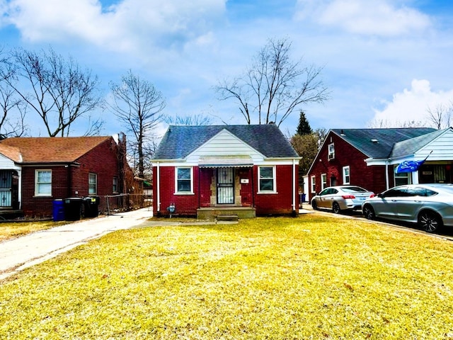 16476 Rossini Dr, Detroit, MI 48205 - bungalow featuring brick siding, a front lawn, and fence