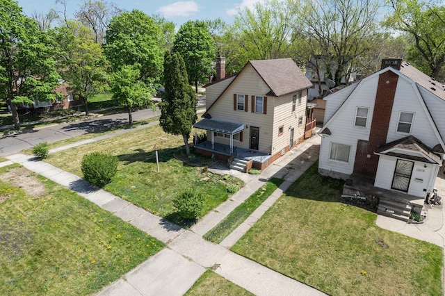 view of front of home featuring a chimney and a front yard