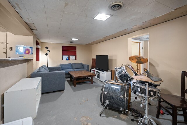 living area featuring visible vents and concrete floors