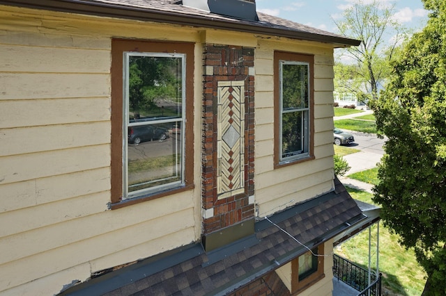 view of property exterior with a shingled roof