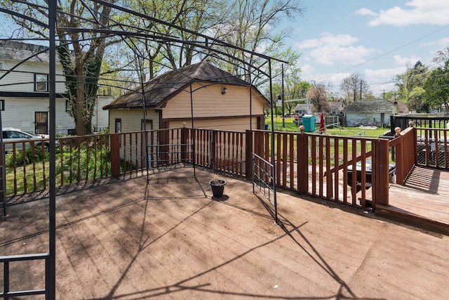view of patio / terrace with a deck, an outbuilding, and a detached garage