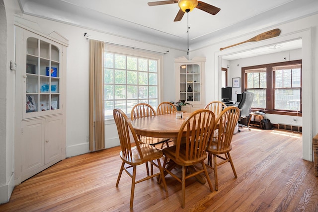 dining space featuring ceiling fan, baseboards, a healthy amount of sunlight, and light wood-style floors