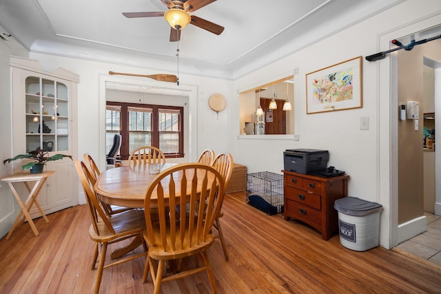 dining area featuring light wood-style flooring and ceiling fan