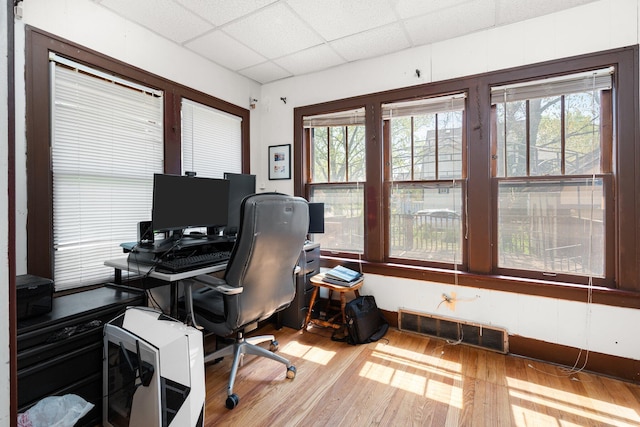 home office featuring a drop ceiling, visible vents, and wood finished floors
