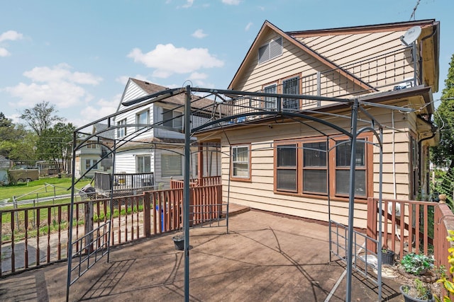 rear view of house with a balcony and a patio area