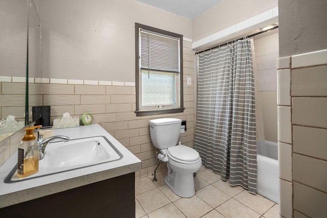 18511 Margareta St, Detroit, MI 48219 - bathroom with vanity, tile patterned floors, tile walls, shower / bath combo with shower curtain, and a wainscoted wall