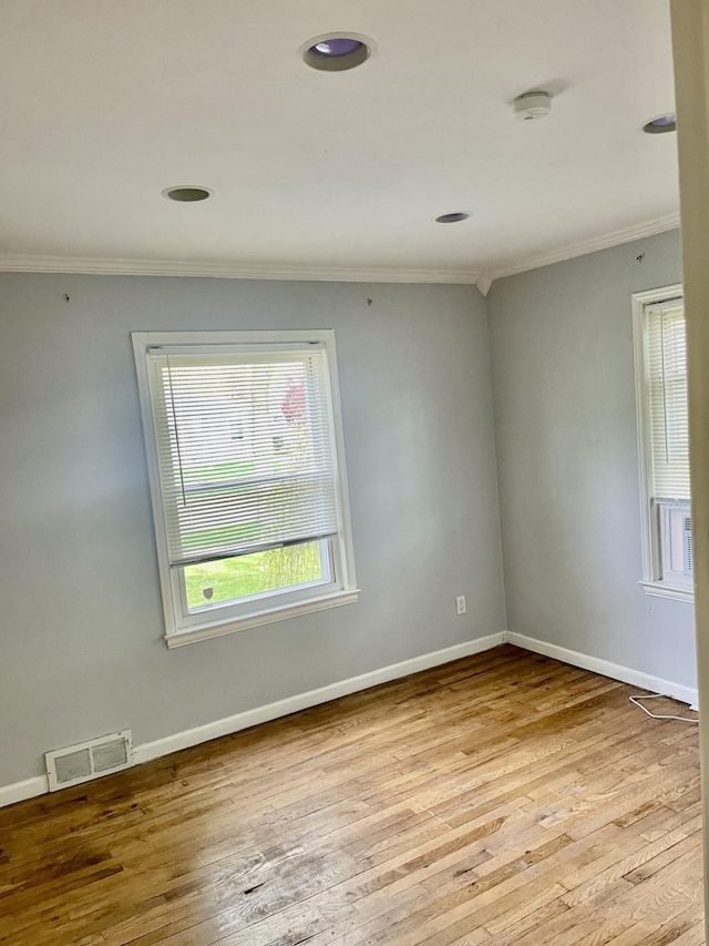 unfurnished room with ornamental molding, a smoke detector, wood-type flooring, baseboards, and recessed lighting