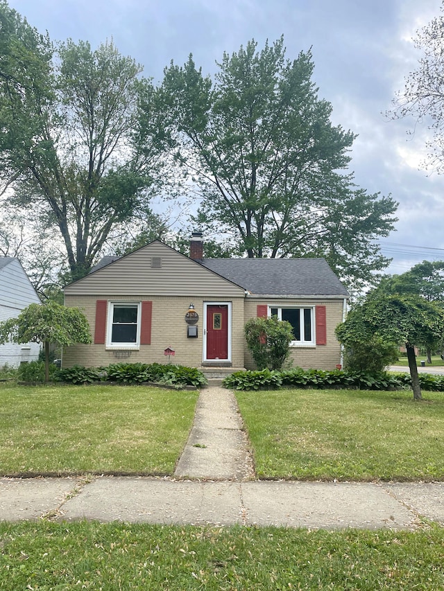 2575 Ellwood Ave, Berkley, MI 48072 - view of front of property featuring brick siding, a front lawn, and a chimney