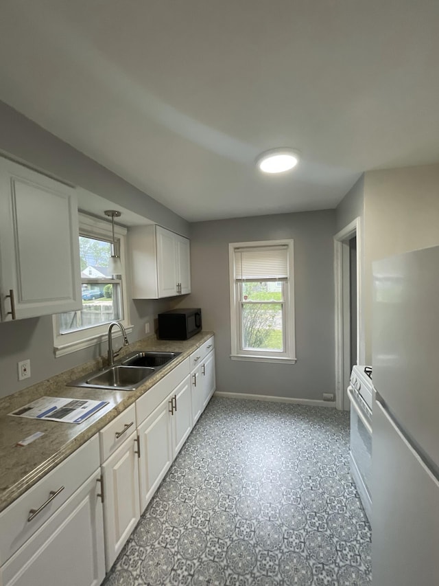 2575 Ellwood Ave, Berkley, MI 48072 - kitchen featuring a sink, white appliances, white cabinetry, and healthy amount of natural light