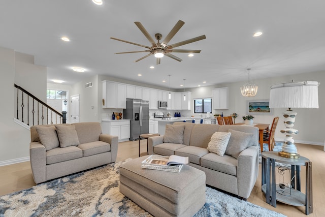 3166 Roma, Wixom, MI 48393 - living room featuring ceiling fan, baseboards, recessed lighting, stairway, and a chandelier