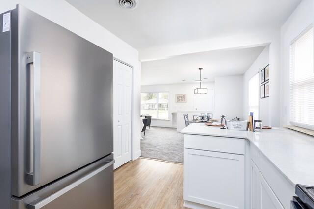 21430 Ridgedale St, Oak Park, MI 48237 - kitchen with freestanding refrigerator, visible vents, stove, light countertops, and light wood-style floors