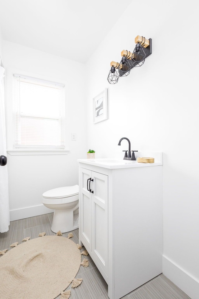 21430 Ridgedale St, Oak Park, MI 48237 - bathroom with vanity, toilet, and baseboards