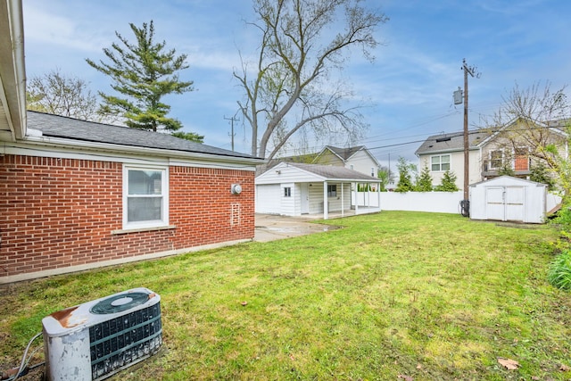 21430 Ridgedale St, Oak Park, MI 48237 - view of yard with fence, a patio area, a storage unit, and an outbuilding