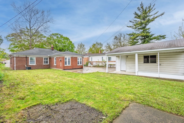 21430 Ridgedale St, Oak Park, MI 48237 - back of property with a patio, a yard, brick siding, and a chimney