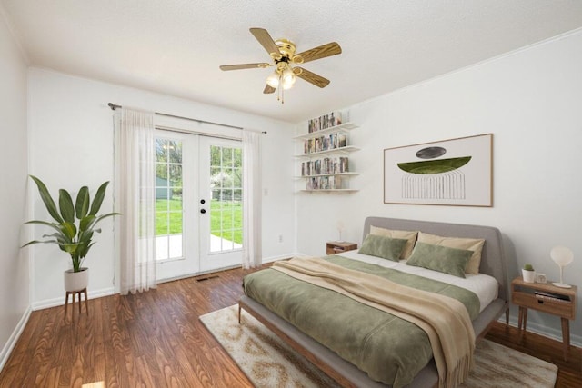 bedroom with french doors, wood finished floors, baseboards, visible vents, and access to outside