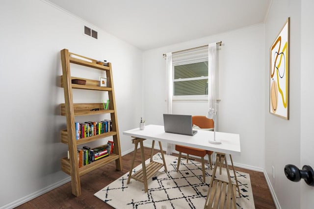 office space featuring baseboards, visible vents, and wood finished floors