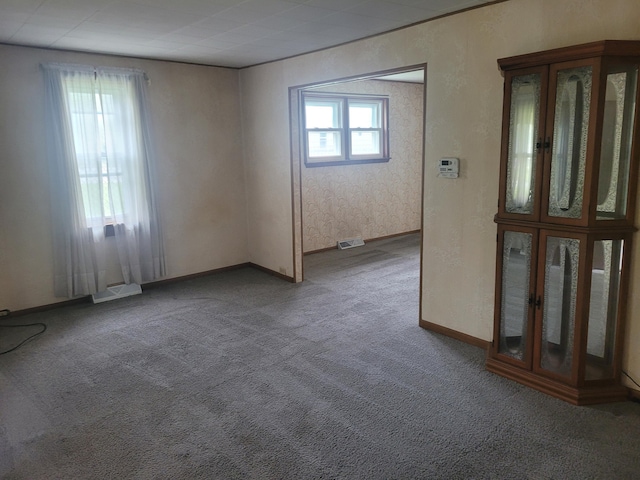 carpeted spare room with baseboards