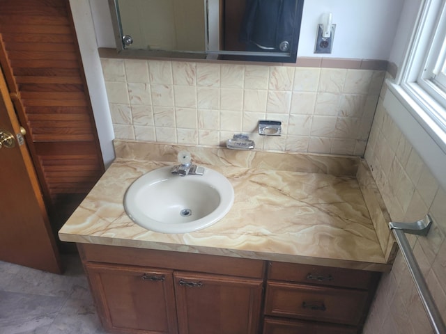bathroom featuring vanity and backsplash
