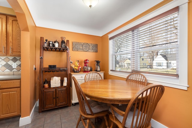 dining room featuring tile patterned floors and baseboards
