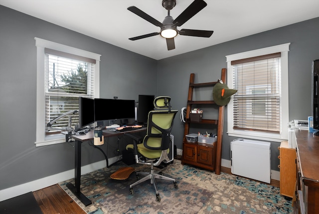 office featuring baseboards, a ceiling fan, and wood finished floors