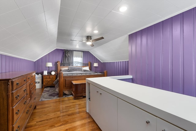 bedroom featuring light wood-type flooring, ceiling fan, and vaulted ceiling