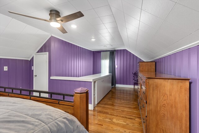 bedroom featuring lofted ceiling, baseboards, a ceiling fan, and wood finished floors