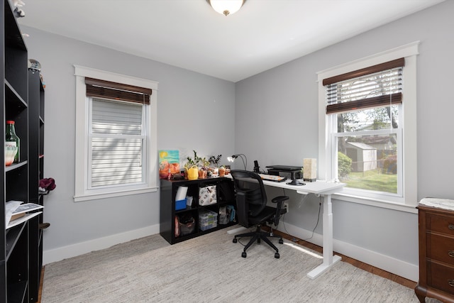 office area with baseboards and light wood-style flooring