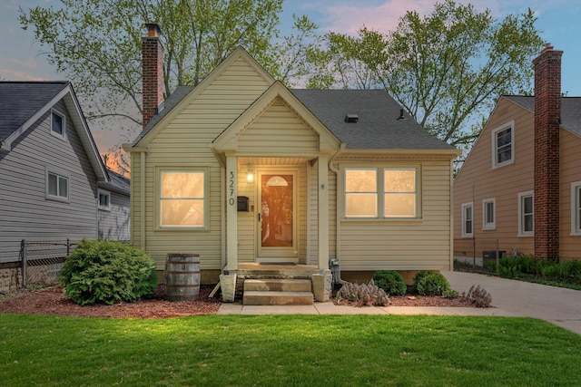 bungalow-style house featuring a chimney and central AC