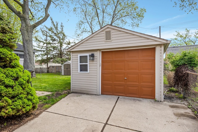 detached garage with concrete driveway