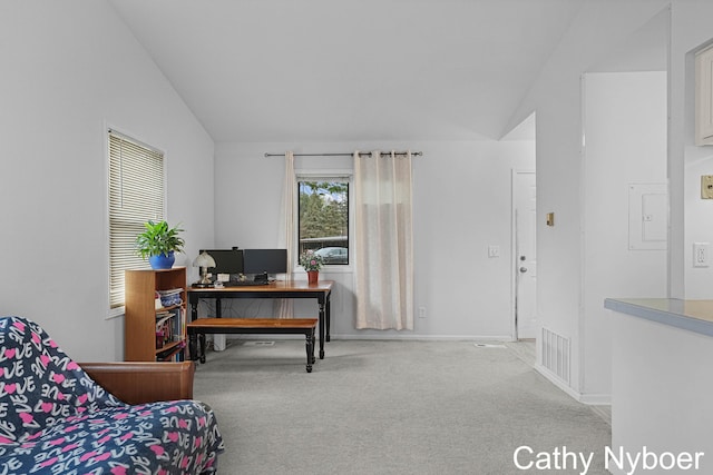 office space featuring carpet floors, lofted ceiling, and baseboards
