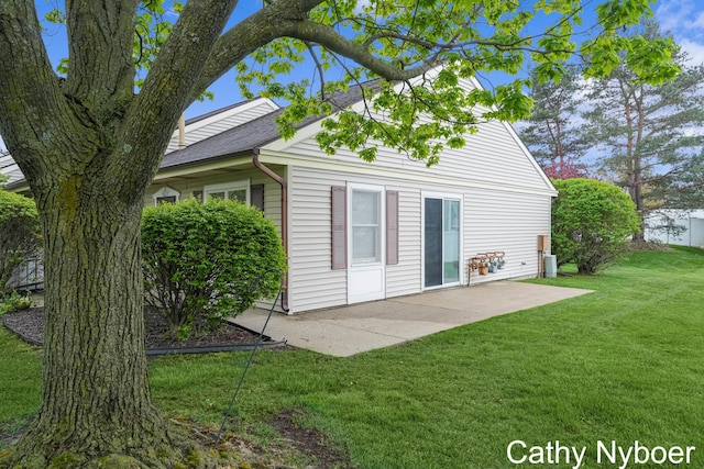 back of property featuring a patio and a lawn