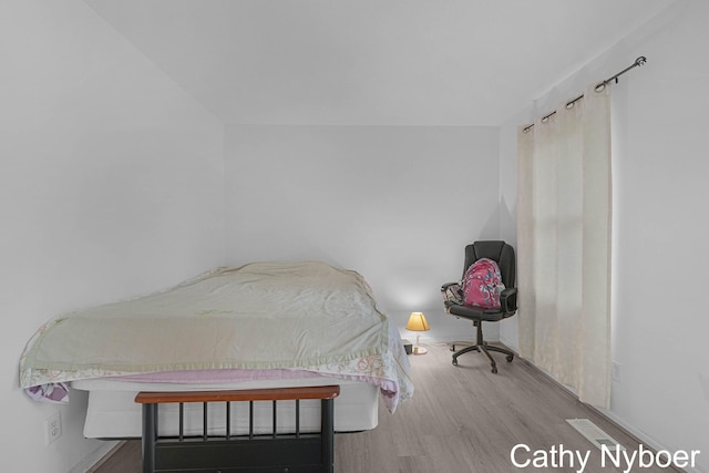 bedroom featuring wood finished floors