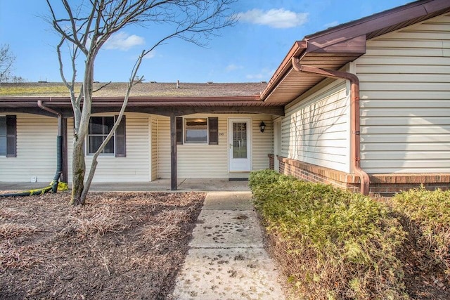 view of exterior entry with brick siding