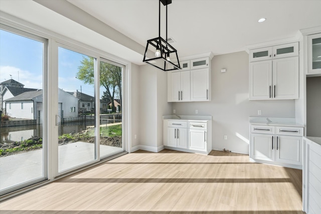 45518 Jefferson Ave, Chesterfield, MI 48047 - kitchen with a chandelier, white cabinetry, hanging light fixtures, glass insert cabinets, and light wood-type flooring