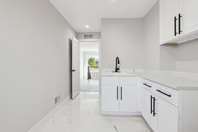 45518 Jefferson Ave, Chesterfield, MI 48047 - kitchen with a sink, light marble finish flooring, recessed lighting, white cabinetry, and baseboards