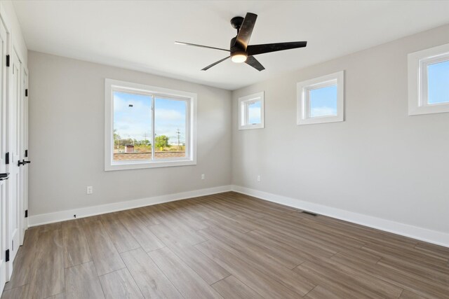 45518 Jefferson Ave, Chesterfield, MI 48047 - unfurnished bedroom with wood finished floors, baseboards, and ceiling fan