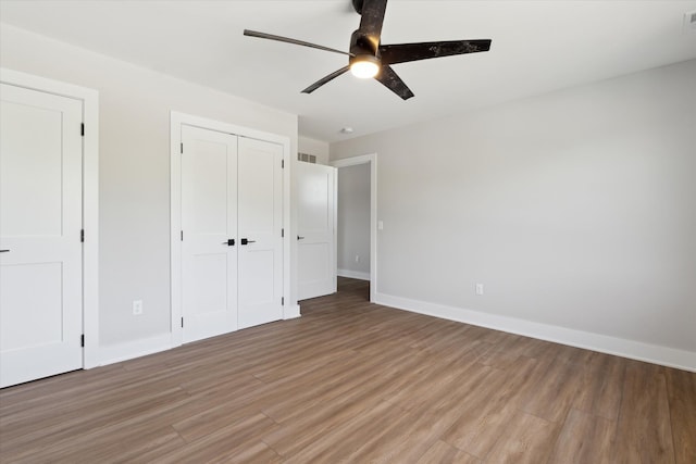 45518 Jefferson Ave, Chesterfield, MI 48047 - unfurnished bedroom featuring light wood-style floors, baseboards, a closet, and ceiling fan