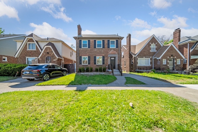 18941 Santa Rosa Dr, Detroit, MI 48221 - view of front facade featuring concrete driveway, a front yard, and brick siding