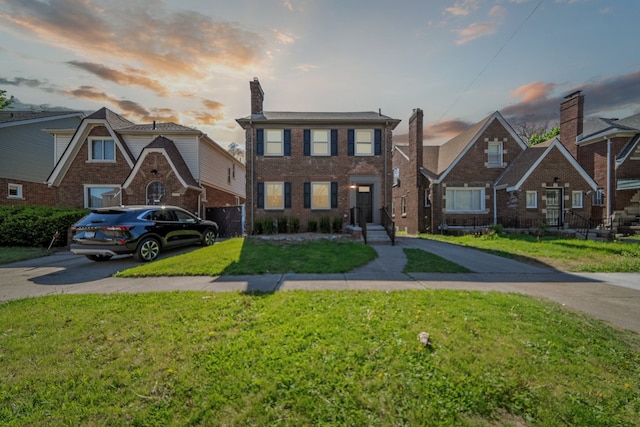 18941 Santa Rosa Dr, Detroit, MI 48221 - view of front of house with driveway, brick siding, and a lawn