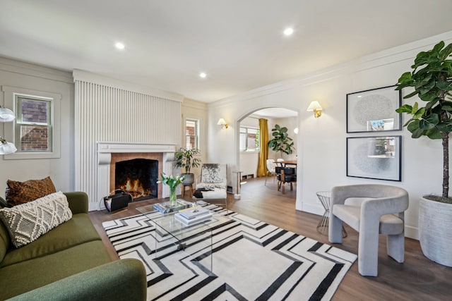 18941 Santa Rosa Dr, Detroit, MI 48221 - living area with arched walkways, wood finished floors, crown molding, a fireplace, and recessed lighting