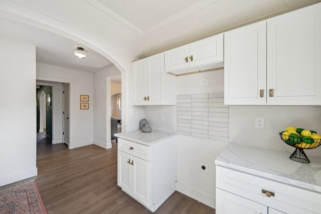18941 Santa Rosa Dr, Detroit, MI 48221 - kitchen featuring arched walkways, dark wood-style flooring, light stone countertops, baseboards, and white cabinets