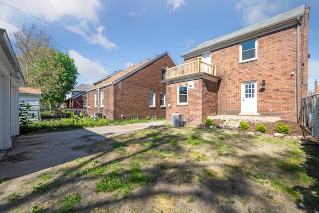 18941 Santa Rosa Dr, Detroit, MI 48221 - back of property featuring a balcony, brick siding, fence, and central air condition unit