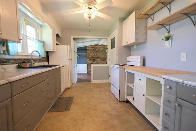 kitchen featuring open shelves, white appliances, and gray cabinets