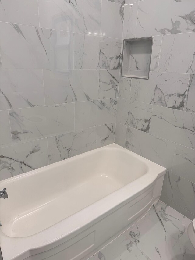9340 Mansfield St, Detroit, MI 48228 - bathroom featuring marble look tiles and a tub to relax in